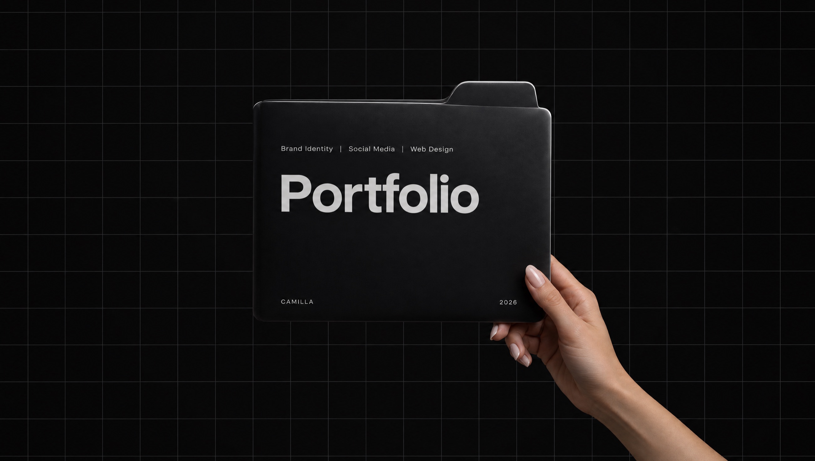 A hand holding a black folder labeled Portfolio — Camilla, 2026